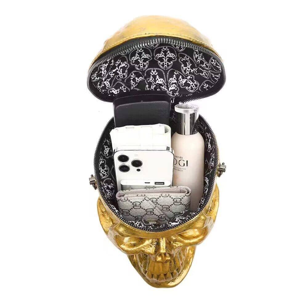 Gold skull 3D handle shoulder bag by Rossie Viren featuring compact design and mini handle for cross body and hand use.