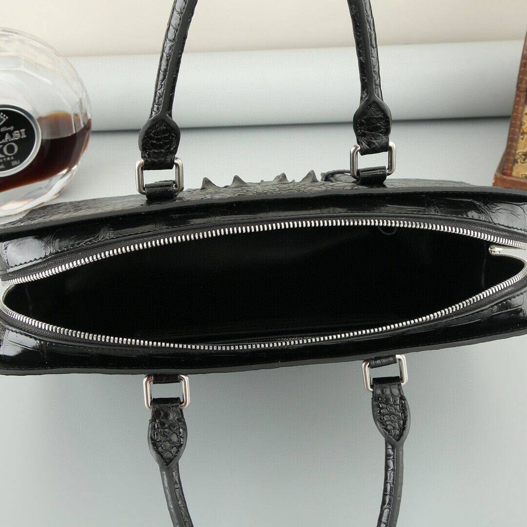 Rossie Viren crocodile leather briefcase in black and brown with sturdy handles and sleek design.