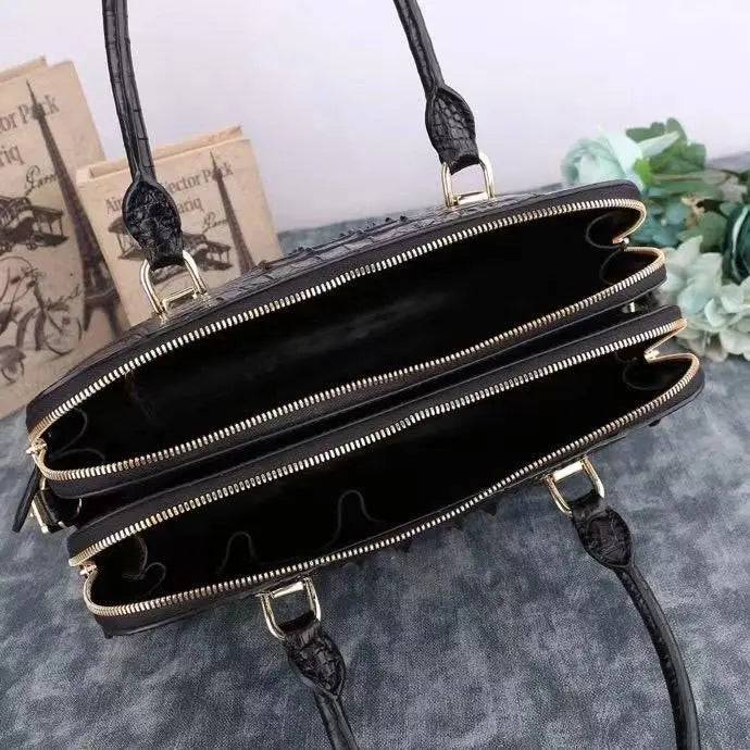 Black crocodile leather briefcase handbag with shell-style design by Rossie Viren, featuring a textured crocodile pattern and sturdy handle.