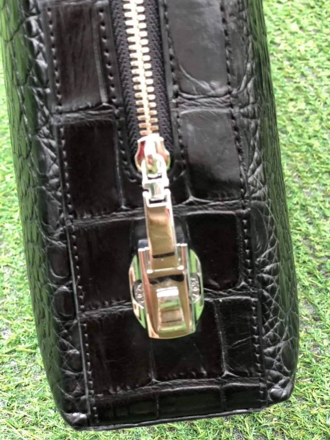 Black genuine crocodile leather briefcase by Rossie Viren with side password lock, featuring a sleek, textured crocodile pattern and sturdy handle.