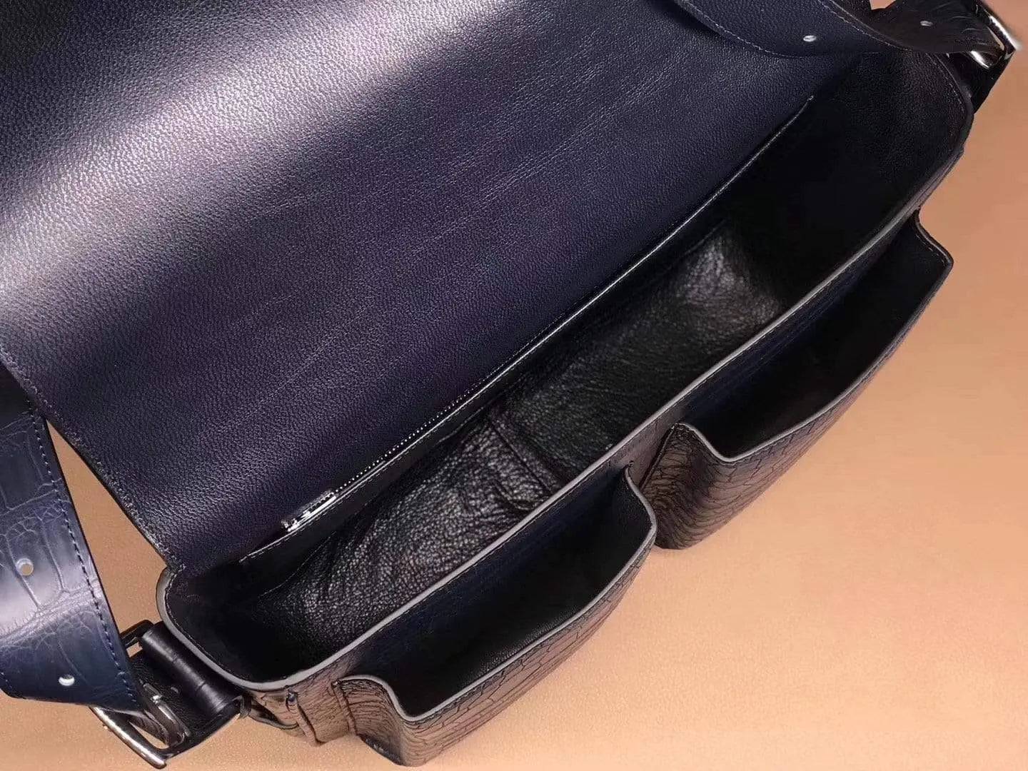Rossie Viren crocodile garment leather medium messenger bag featuring a soft, textured leather exterior and adjustable shoulder strap.
