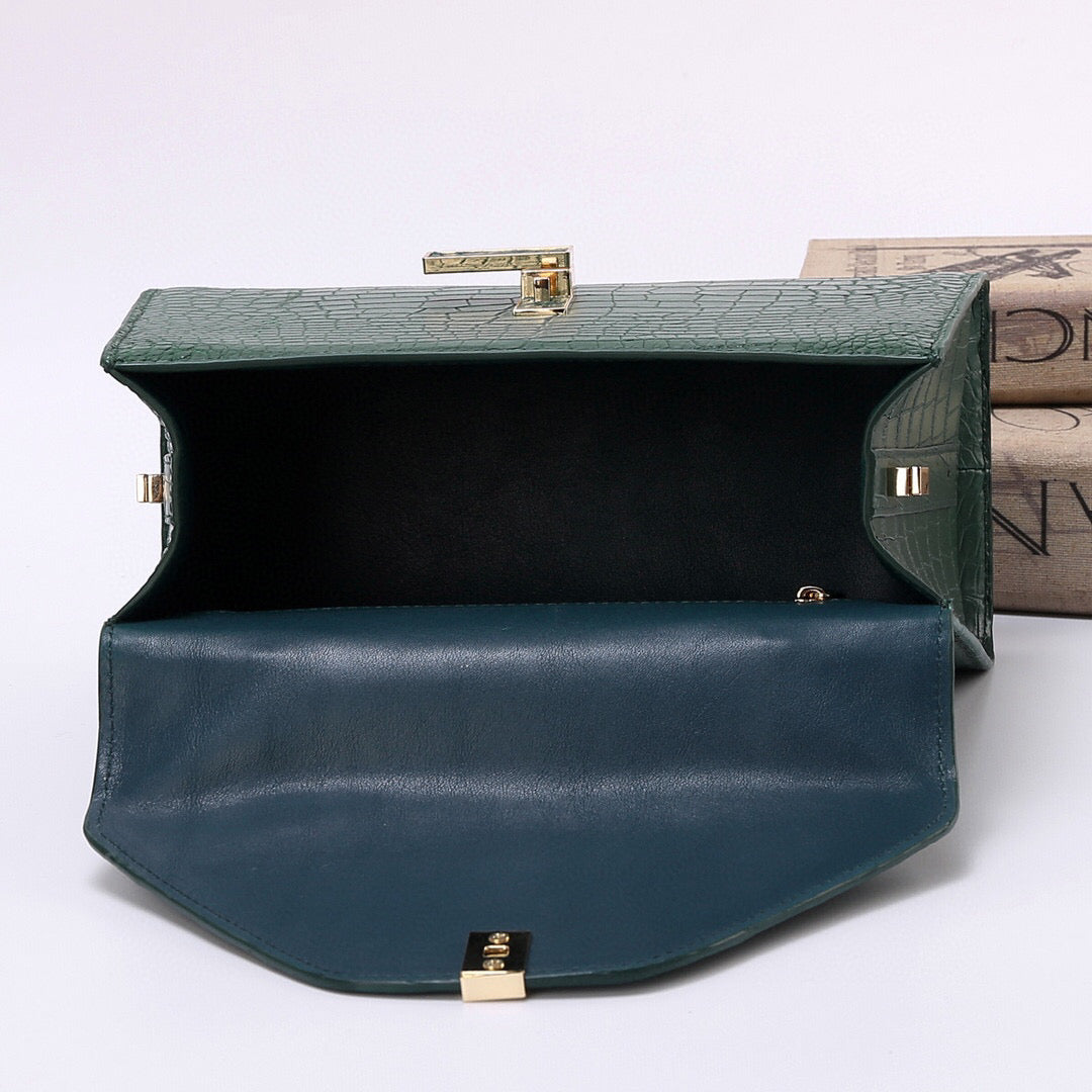 Dark green genuine crocodile skin leather top handle bag by Rossie Viren with sturdy top handle and elegant design.