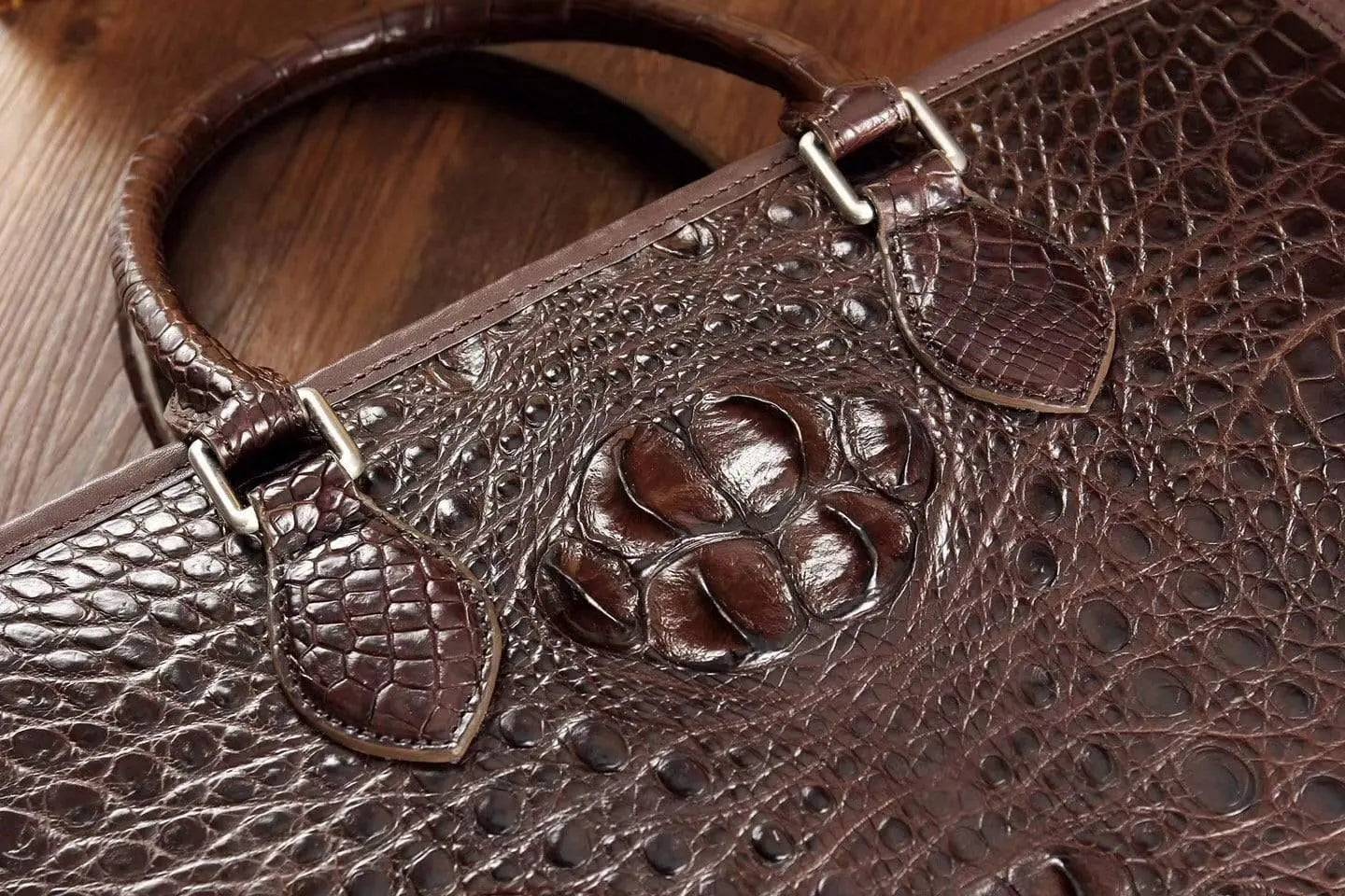 Men's crocodile leather briefcase by Rossie Viren with top handle, featuring a sleek, professional design and textured crocodile pattern.
