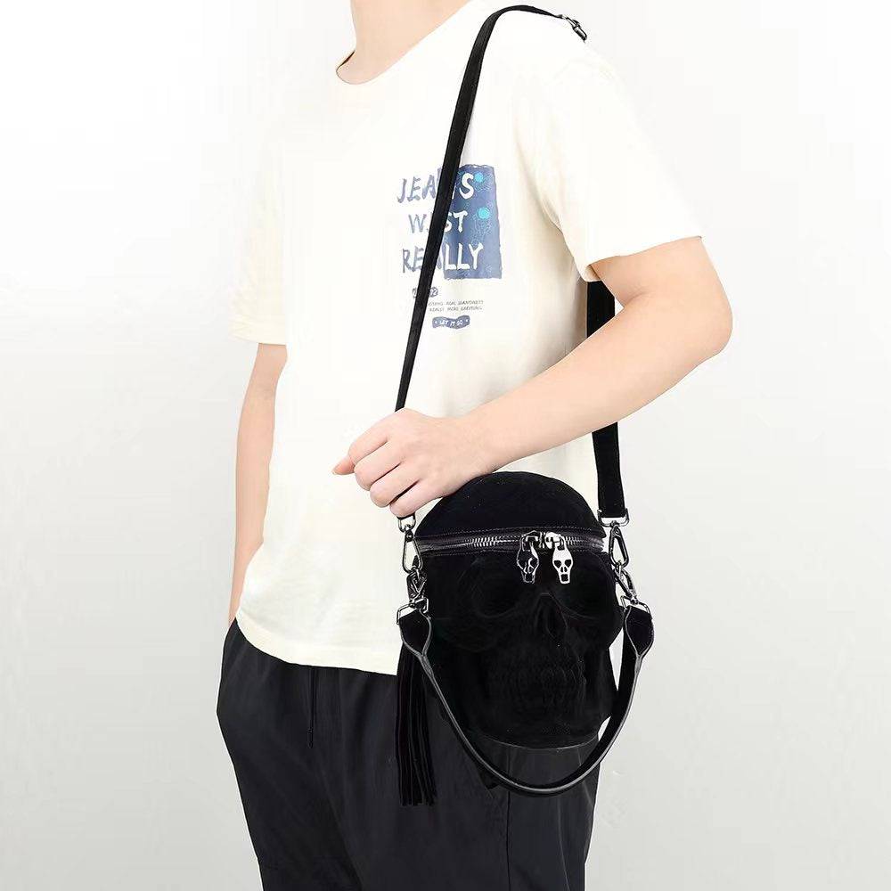 Black suede 3D skull crossbody handle bag by Rossie Viren, compact design with mini handle and shoulder strap, stylish accessory.