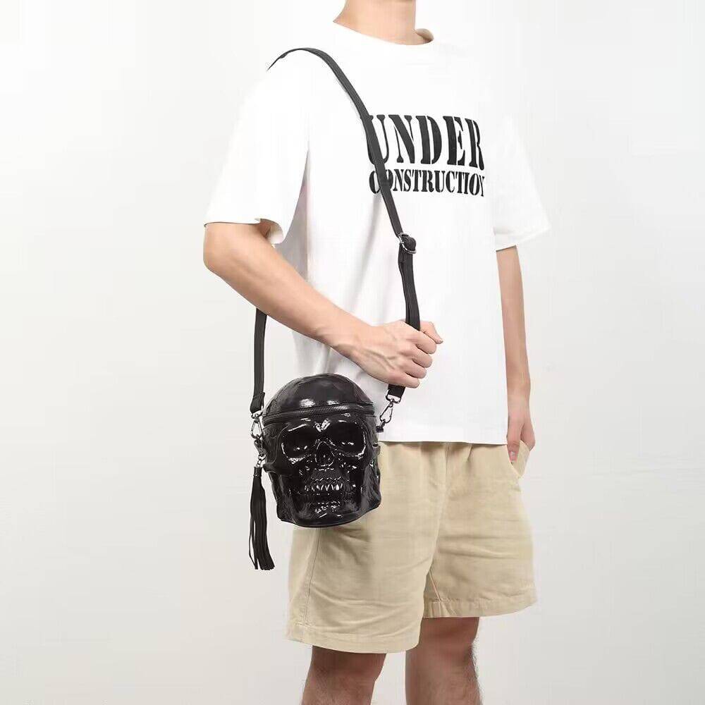 Black 3D skull crossbody handle bag by Rossie Viren featuring a compact design with a mini handle and shoulder strap.