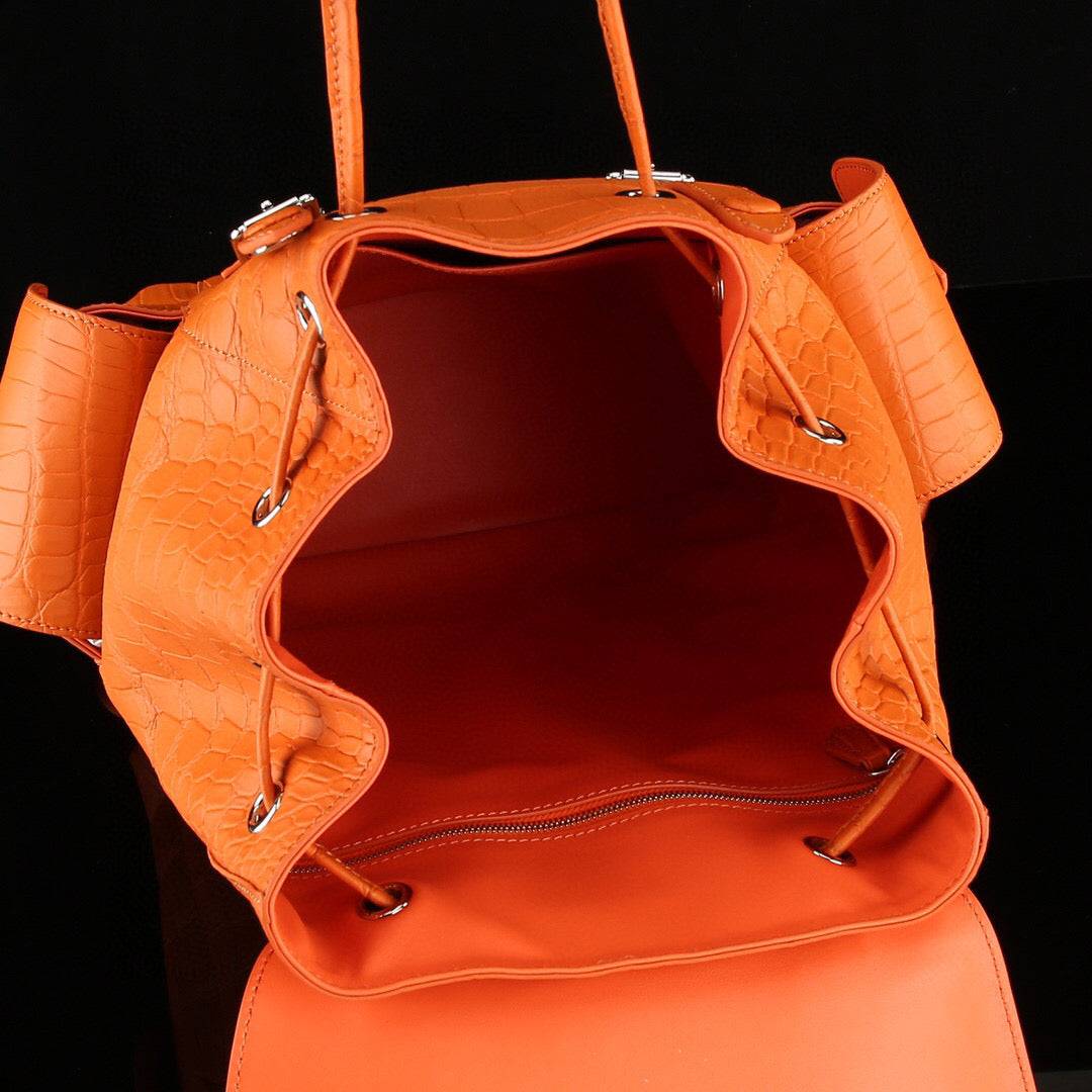 Orange crocodile leather backpack by Rossie Viren featuring a textured crocodile pattern and sturdy straps.