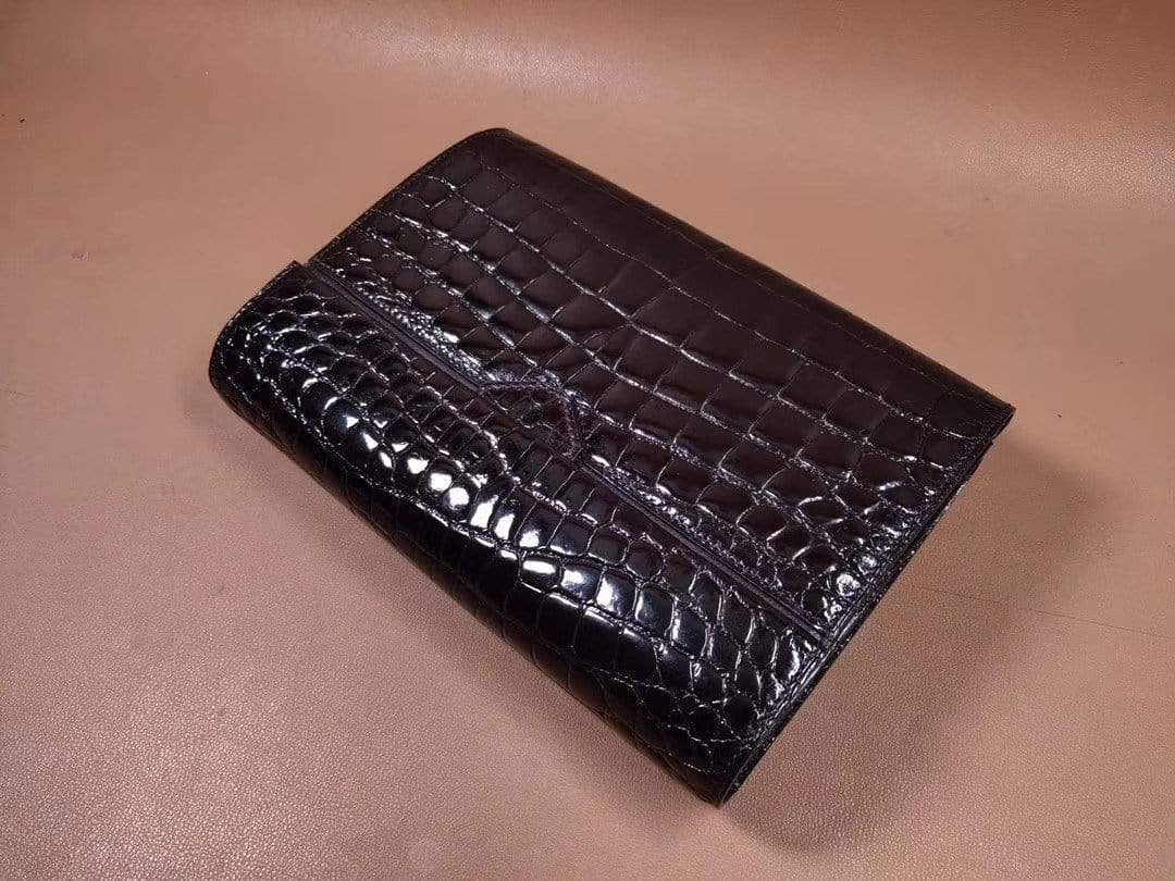 Mens black crocodile leather clutch bag with high gloss finish and baking bead detailing, by Rossie Viren.