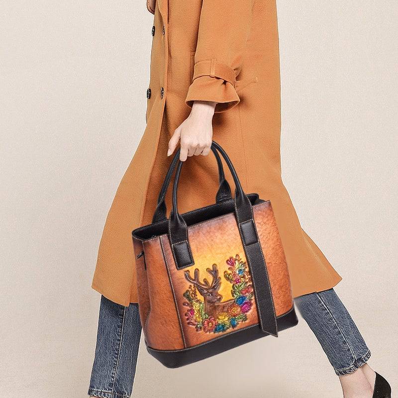 Rossie Viren women's leather handbag featuring a top handle, shoulder strap, and spacious tote design in classic leather.