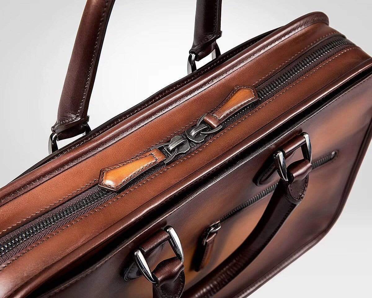 Vintage smooth cowhide leather handbag by Rossie Viren, featuring a classic messenger bag design with elegant stitching.