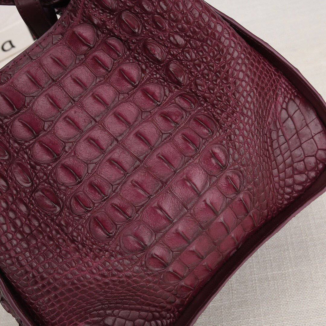 Women’s genuine crocodile leather handbag by Rossie Viren with top handle and slouchy shoulder strap, showcasing luxurious texture and design.