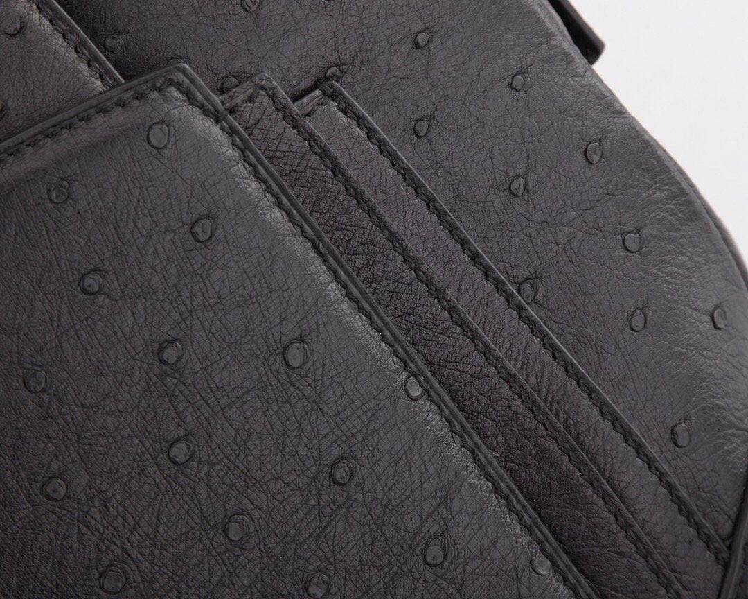 Women's ostrich leather shoulder handbag with top handle by Rossie Viren, featuring a sleek and elegant design.