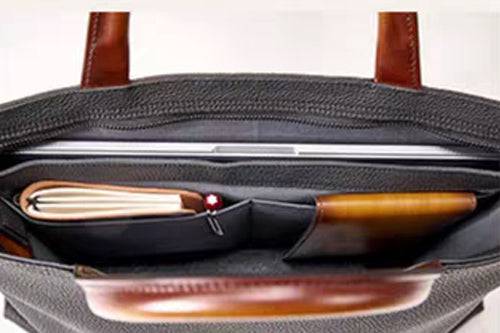 Black 14-inch imported grainy leather laptop briefcase bag by Rossie Viren, featuring a classic handbag design with sturdy handles.