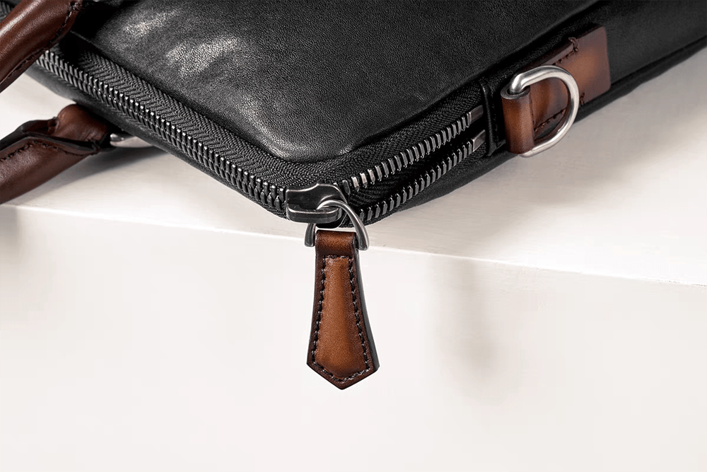 Black 15-inch Rossie Viren imported calfskin leather laptop briefcase bag with classic design and sturdy handle.