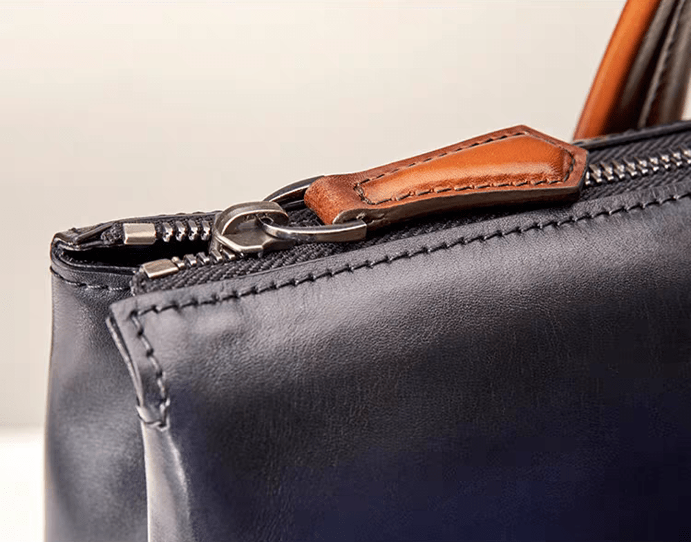 Vintage 15-inch leather laptop briefcase handbag by Rossie Viren, featuring a classic design with sturdy handles and secure closure.