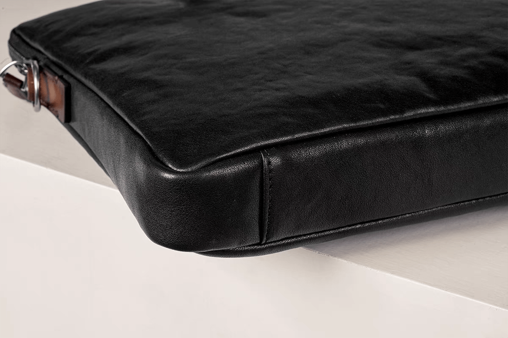 Black 15-inch Rossie Viren calfskin leather laptop briefcase bag with classic design and sturdy handles.