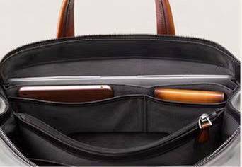 Vintage 15-inch leather laptop briefcase bag by Rossie Viren, featuring a classic handbag design with sturdy handles and sleek leather finish.