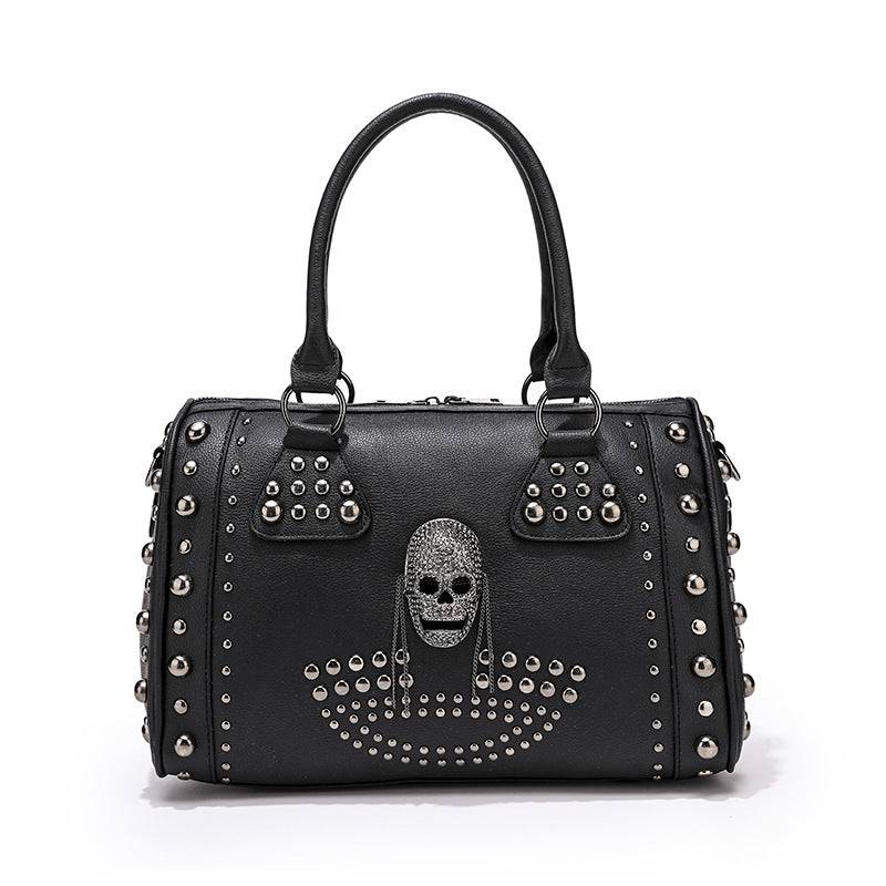 Rossie Viren 3D crystal skull shoulder bag with studded satchel design, featuring a detailed crystal skull embellishment and stud accents.