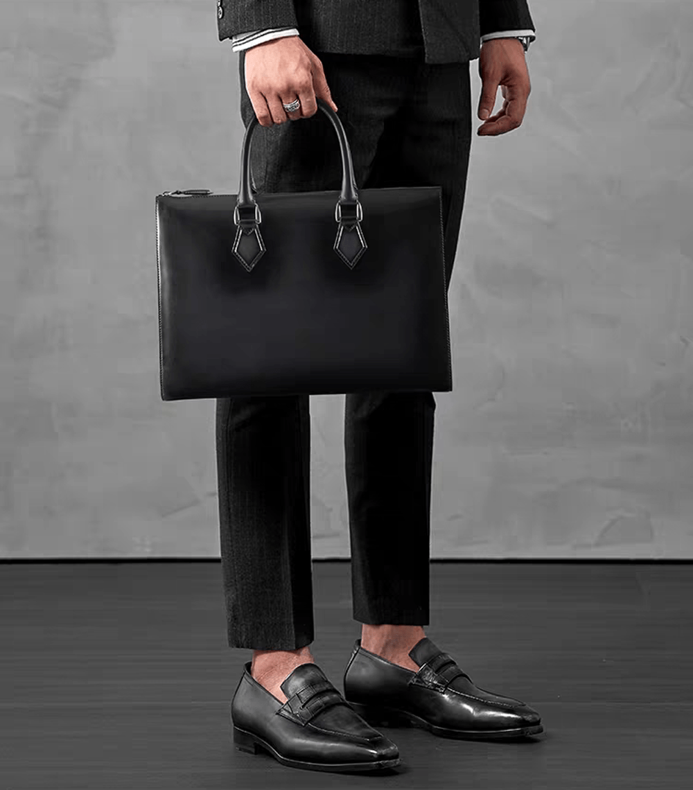 Vintage 14-inch leather laptop briefcase handbag by Rossie Viren, showcasing a classic design with sturdy leather and elegant handles.