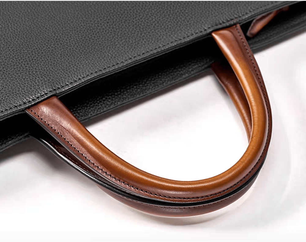 Black 14-inch imported grainy leather laptop briefcase handbag by Rossie Viren, featuring a classic design with sturdy handles.