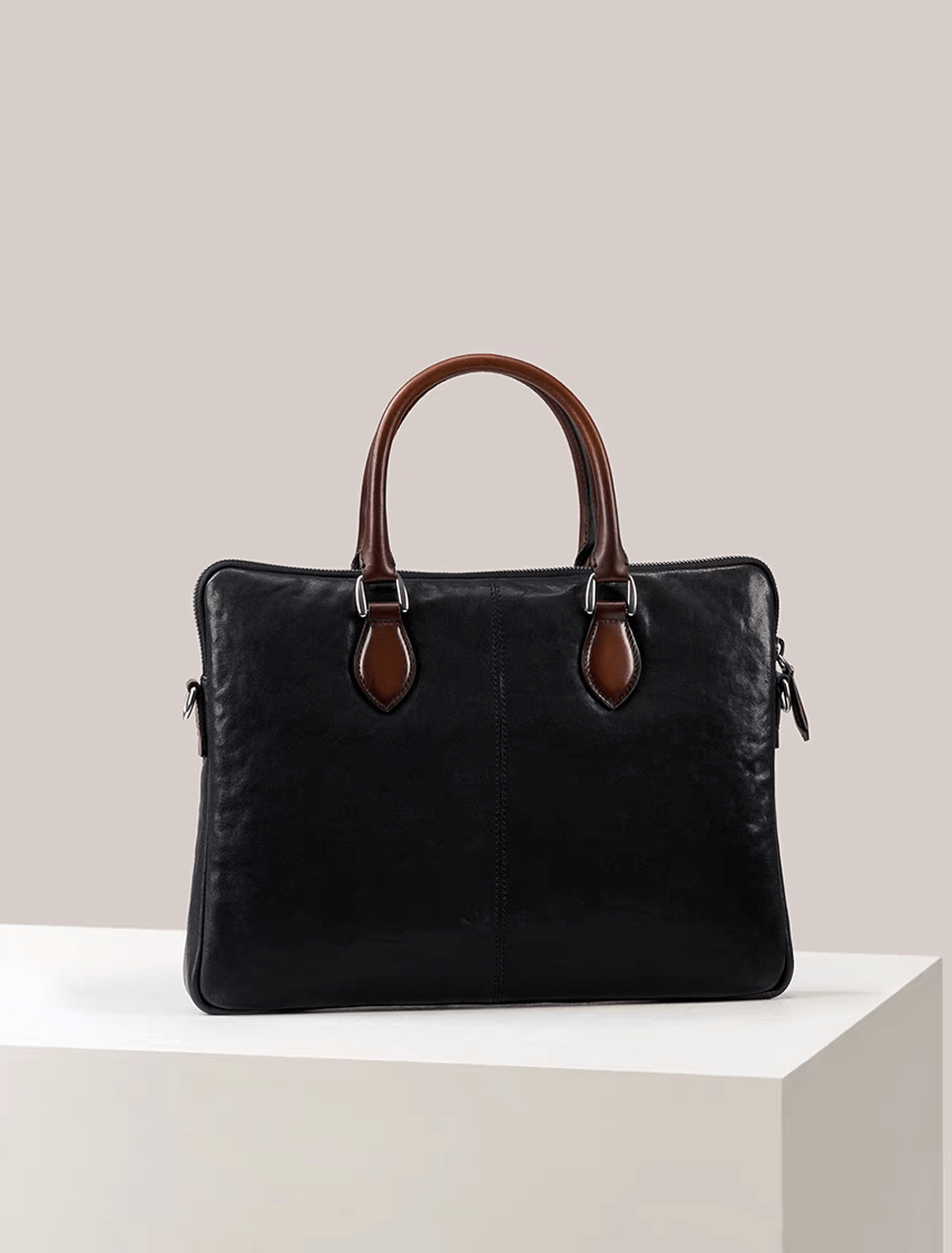 Black 15-inch Rossie Viren calfskin leather laptop briefcase bag with classic design and sturdy handles.