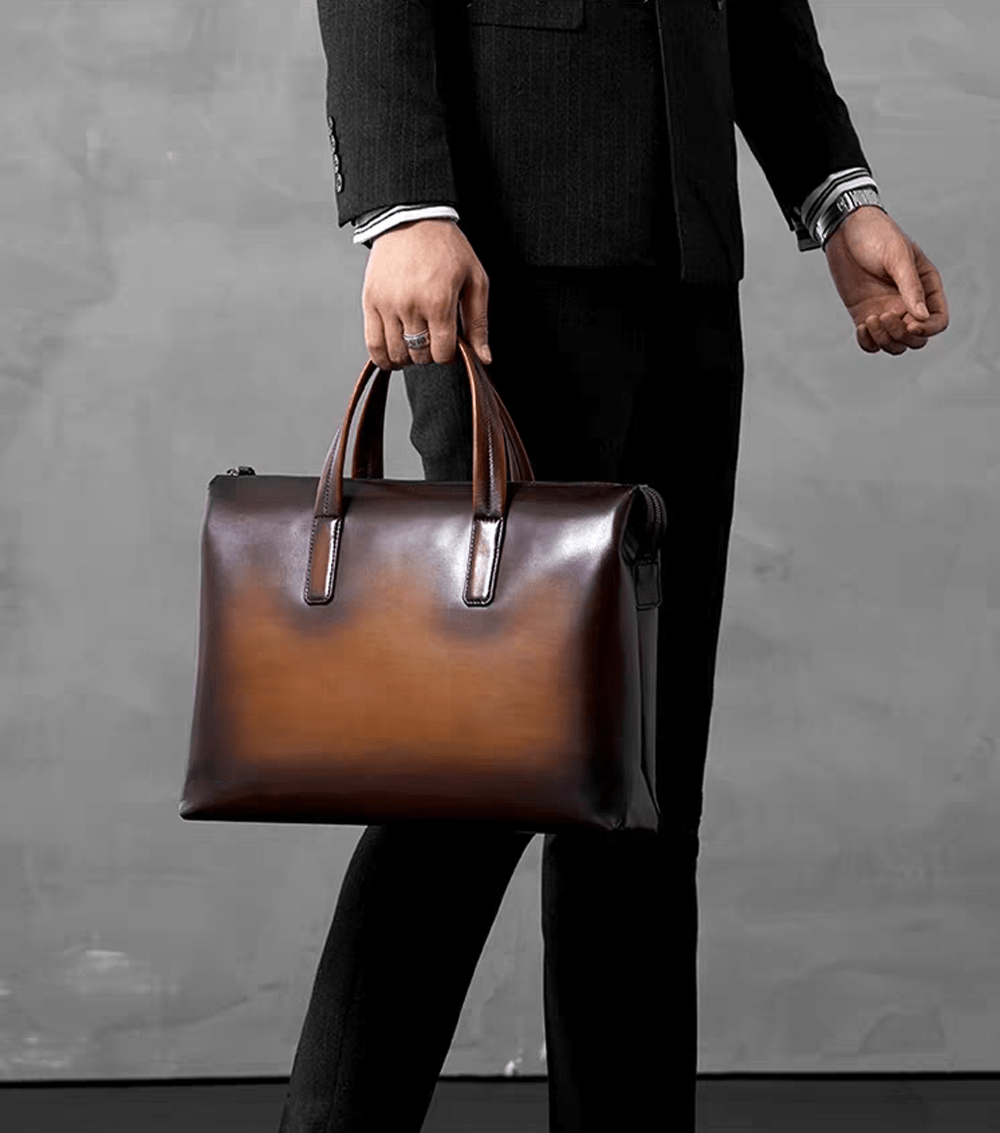Vintage leather 15-inch Rossie Viren laptop briefcase bag with sturdy handles and classic design, suitable for professional use.