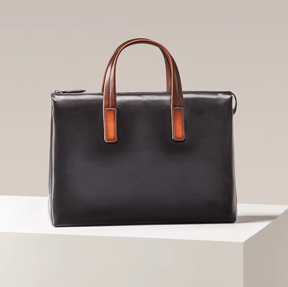 15-inch vintage leather laptop briefcase bag by Rossie Viren featuring classic design and sturdy handles.