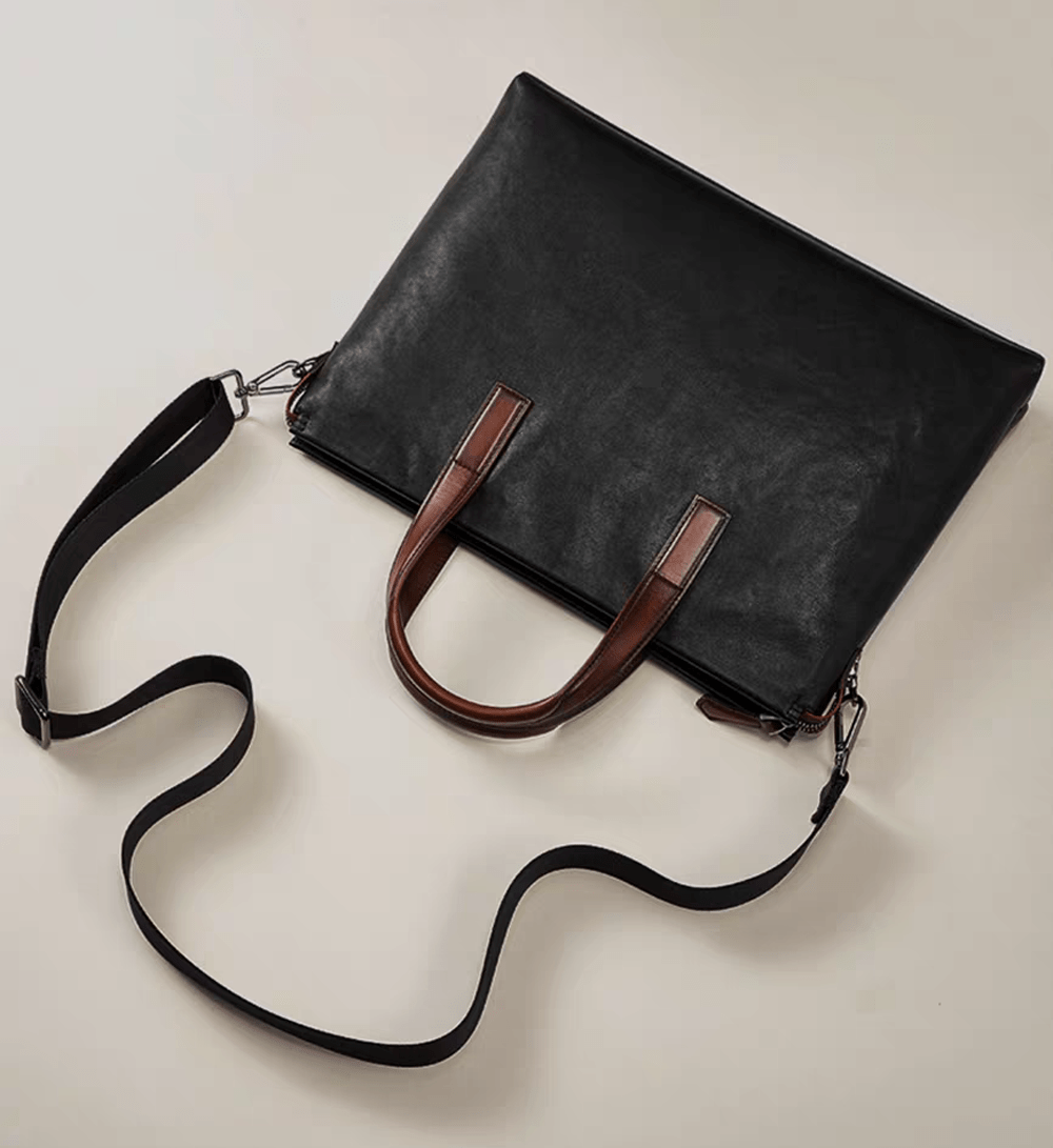 Black 15-inch Togo leather laptop briefcase handbag by Rossie Viren featuring sturdy handles and a sleek professional design.