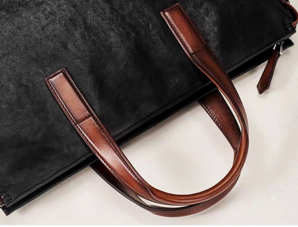 Black 15-inch Togo leather laptop briefcase handbag by Rossie Viren, featuring sturdy handles and sleek design.