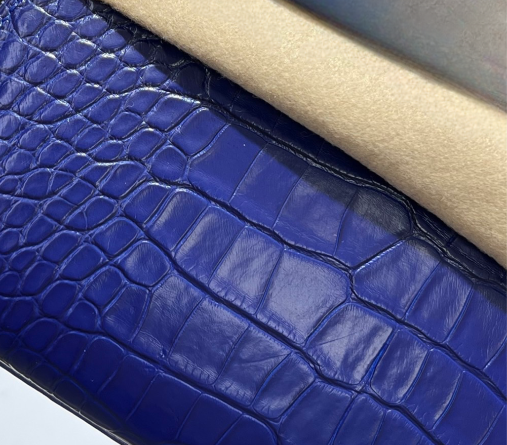 Rossie Viren crocodile leather sling shoulder bag with crossbody strap, featuring a sleek, textured crocodile pattern.