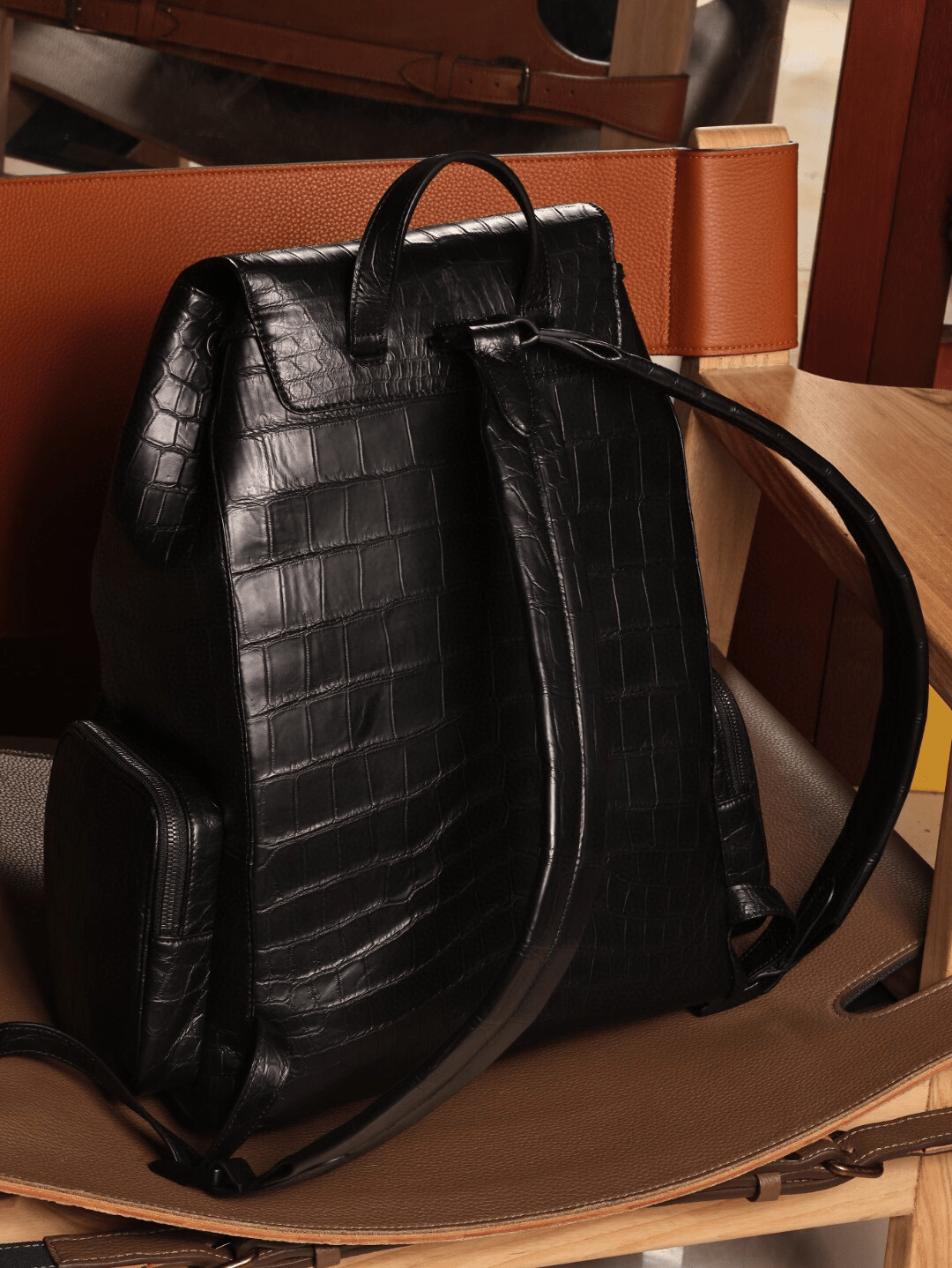 Unisex black crocodile leather handbag by Rossie Viren with sturdy straps and textured surface.
