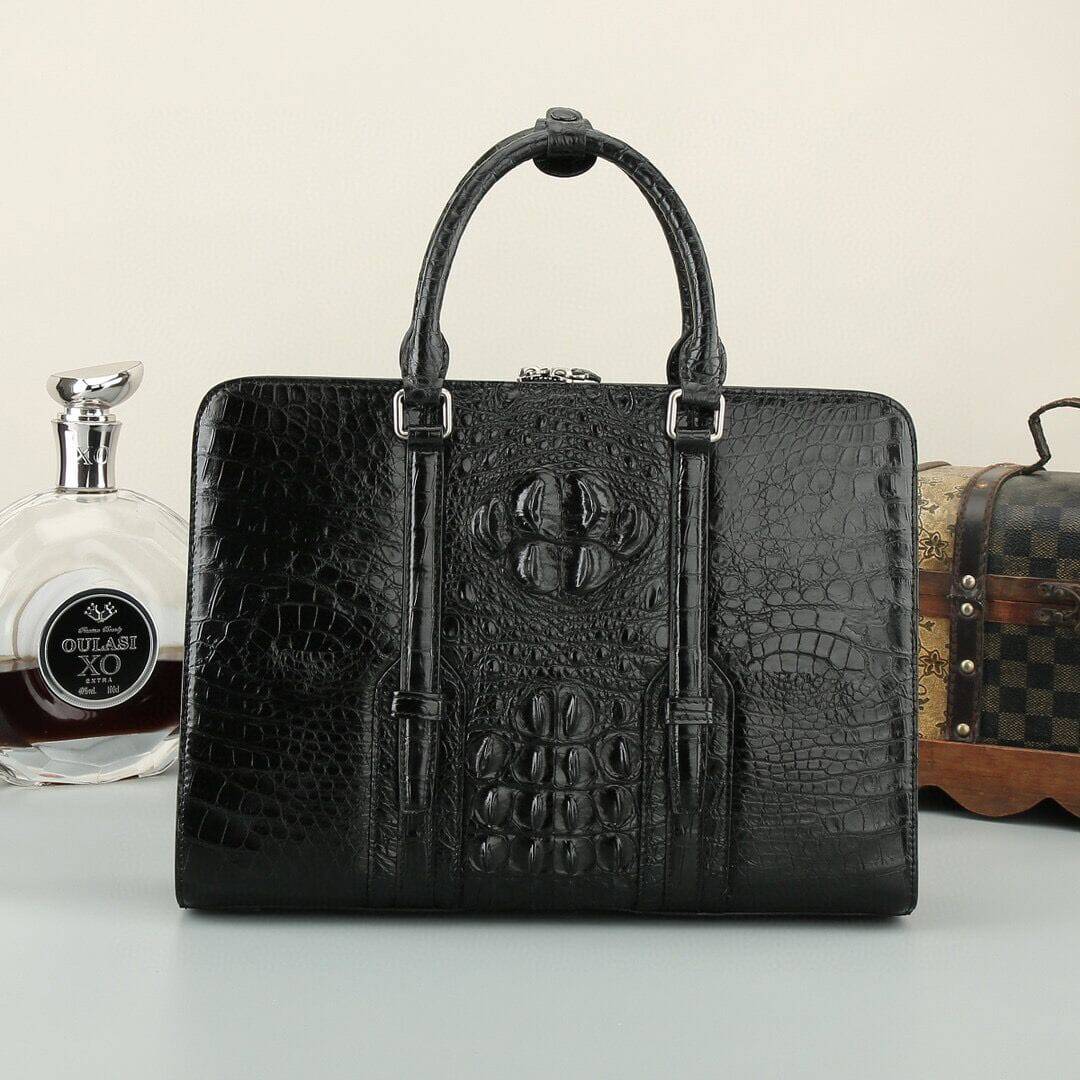 Rossie Viren crocodile leather briefcase handbag in black and brown with textured finish and sturdy handles.
