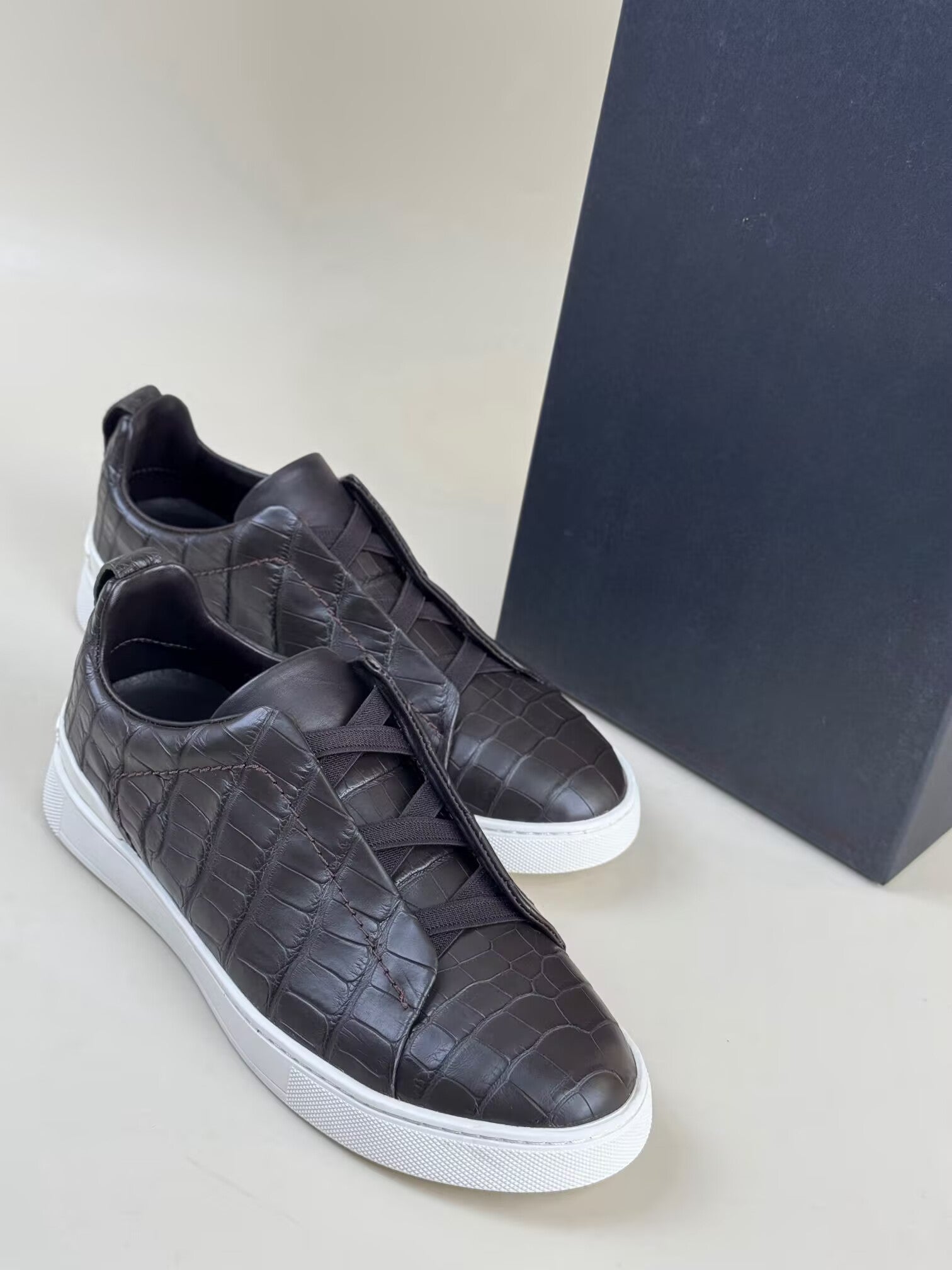 Brown Rossie Viren crocodile skin leather sneakers, genuine crocodile shoes with textured leather uppers and white rubber soles.