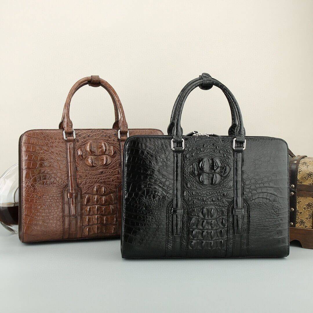 Black and brown crocodile leather briefcase handbag by Rossie Viren with sturdy handles and a sleek, textured finish.