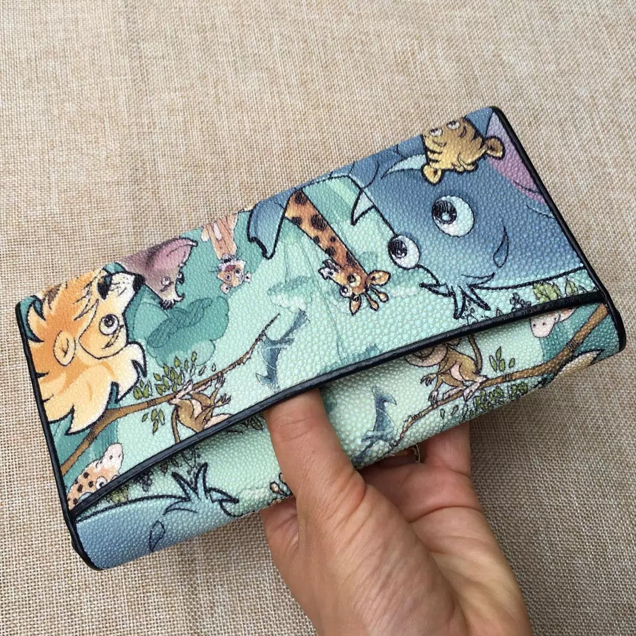 Genuine stingray tri-fold wallet with floral design for women by Rossie Viren, showing textured stingray leather and colorful floral accents.