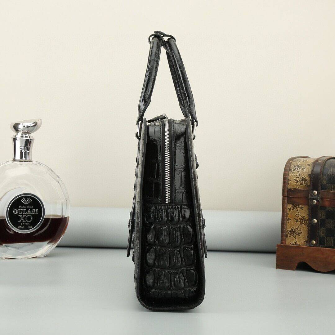 Black and brown crocodile leather briefcase handbag by Rossie Viren with sturdy handles and a sleek, polished design.