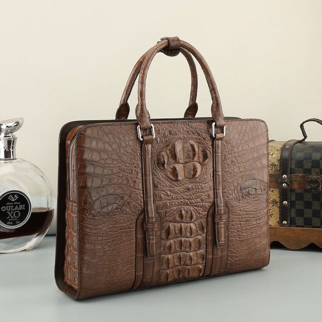 Black and brown crocodile leather briefcase handbag by Rossie Viren with sturdy handles and sleek design.