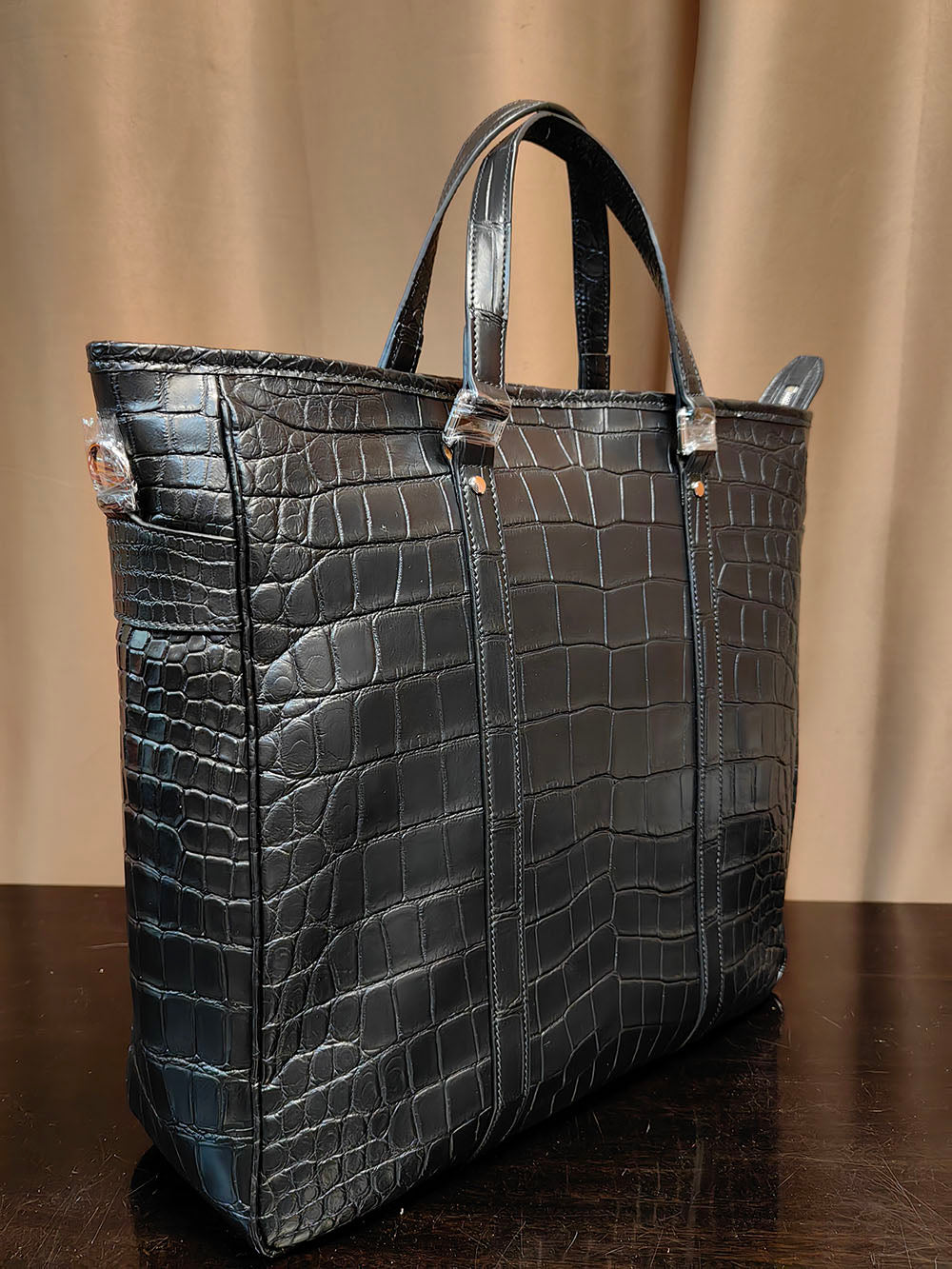 Unisex crocodile leather tote bag by Rossie Viren, large handbag with sturdy handles and sleek crocodile textured surface.