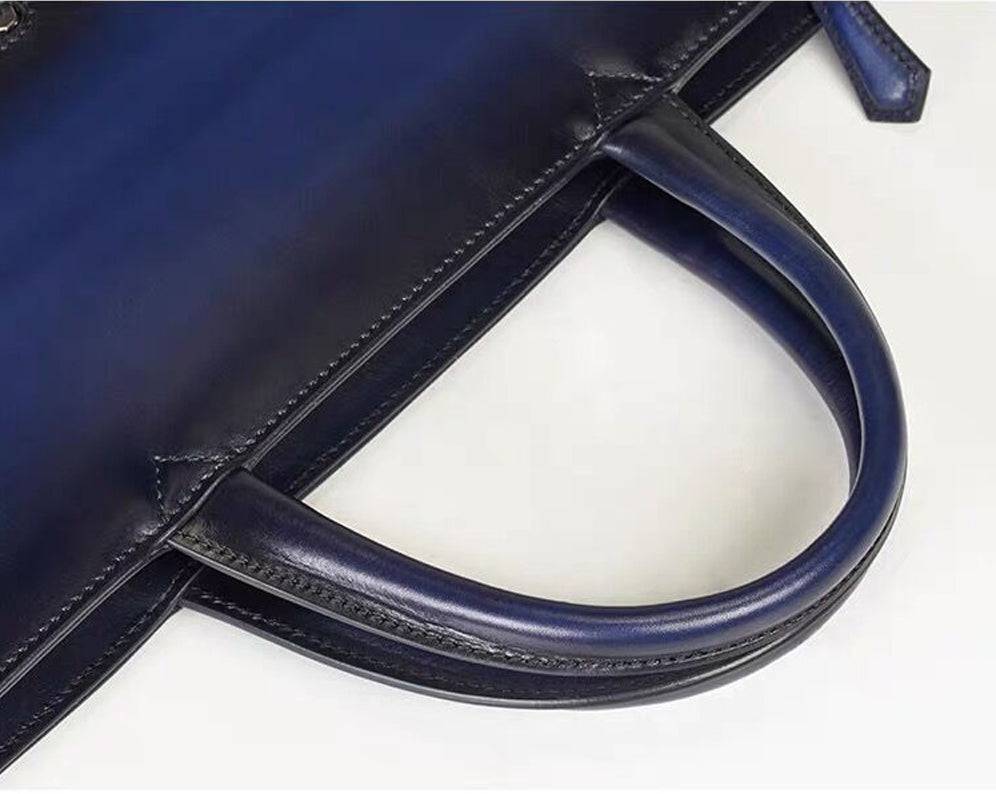 Vintage 15-inch leather laptop briefcase handbag by Rossie Viren with sturdy handles and classic design.