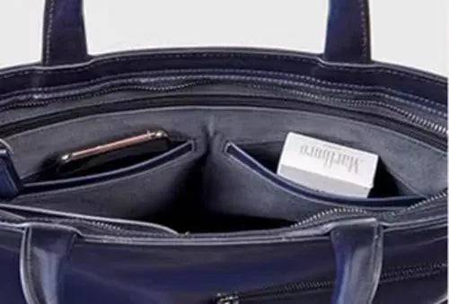 Vintage leather 15-inch laptop briefcase bag by Rossie Viren with sturdy handles and classic design for professional use.