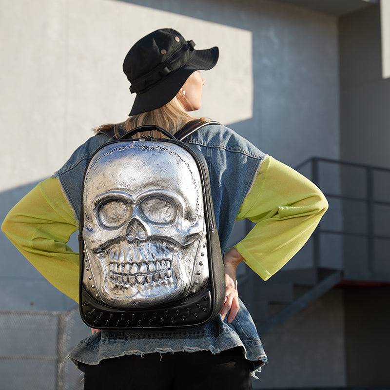 Cool unisex 3D smiling skull backpack with studs, large volume laptop backpack by Rossie Viren, featuring a bold skull design and ample storage.