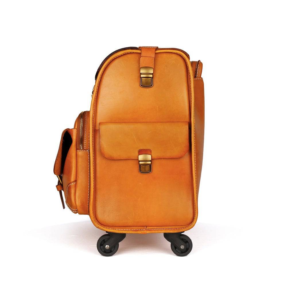 Vintage vegetable tanned leather carry-on rolling luggage by Rossie Viren featuring a classic suitcase design with spinner wheels.