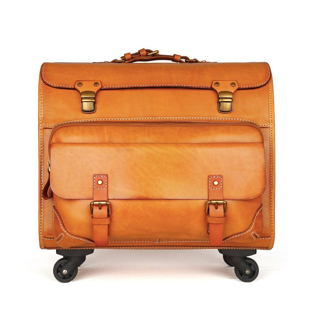 Vintage vegetable tanned leather carry-on rolling suitcase by Rossie Viren, with spinner wheels and classic camel leather finish.
