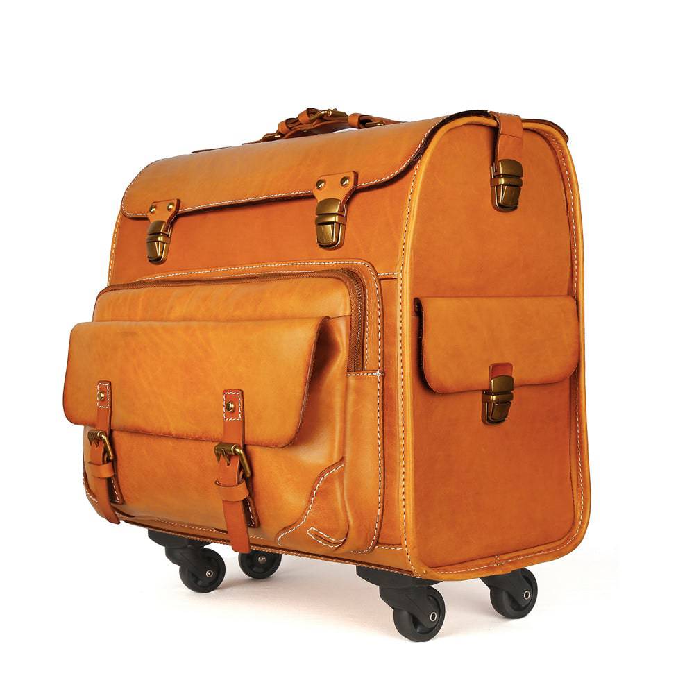 Vintage vegetable tanned leather carry-on rolling suitcase by Rossie Viren, with spinner wheels and classic camel finish.