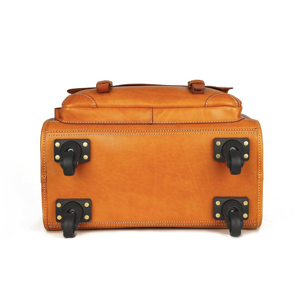 Vintage vegetable tanned leather carry-on rolling suitcase by Rossie Viren, camel color with spinner wheels and classic design.