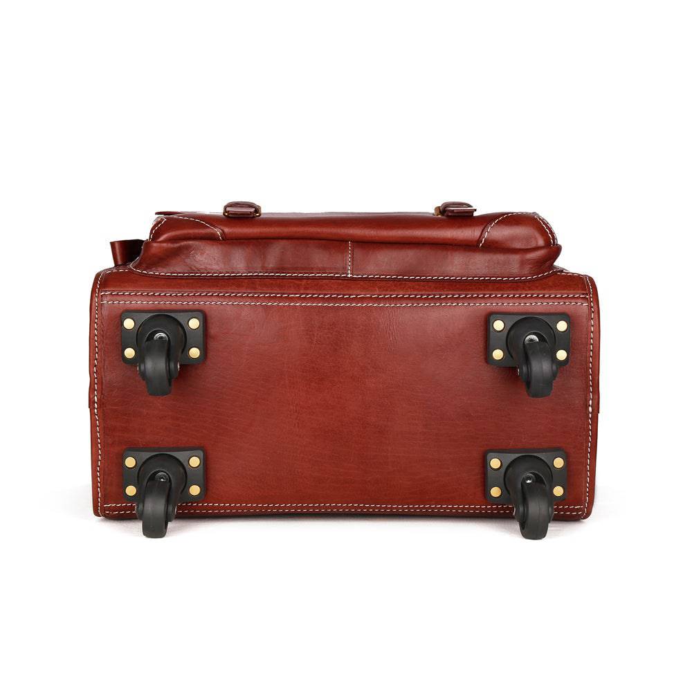 Vintage vegetable tanned leather carry-on rolling suitcase by Rossie Viren, brown with universal spinner wheels and classic vintage style.