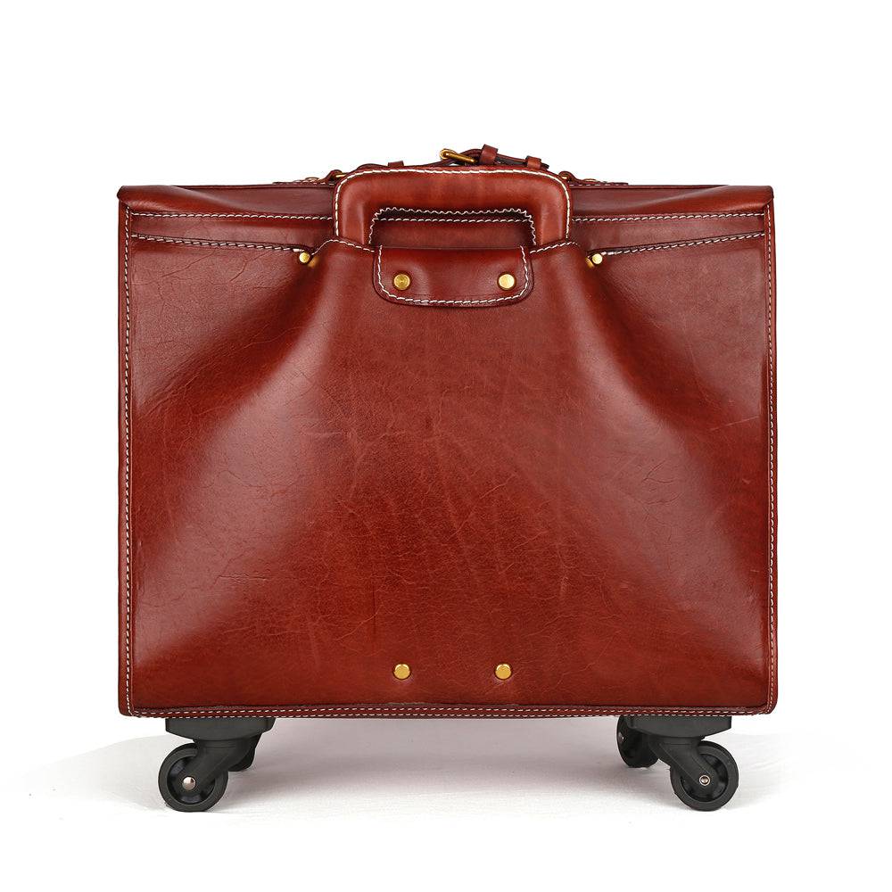 Vintage brown leather carry-on rolling suitcase by Rossie Viren with spinner wheels and classic vegetable tanned leather finish.