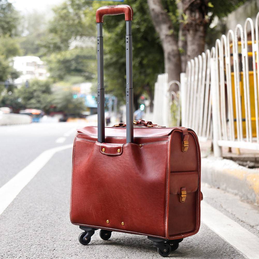Vintage 20-inch vegetable tanned leather carry-on rolling suitcase by Rossie Viren with spinner wheels in brown.