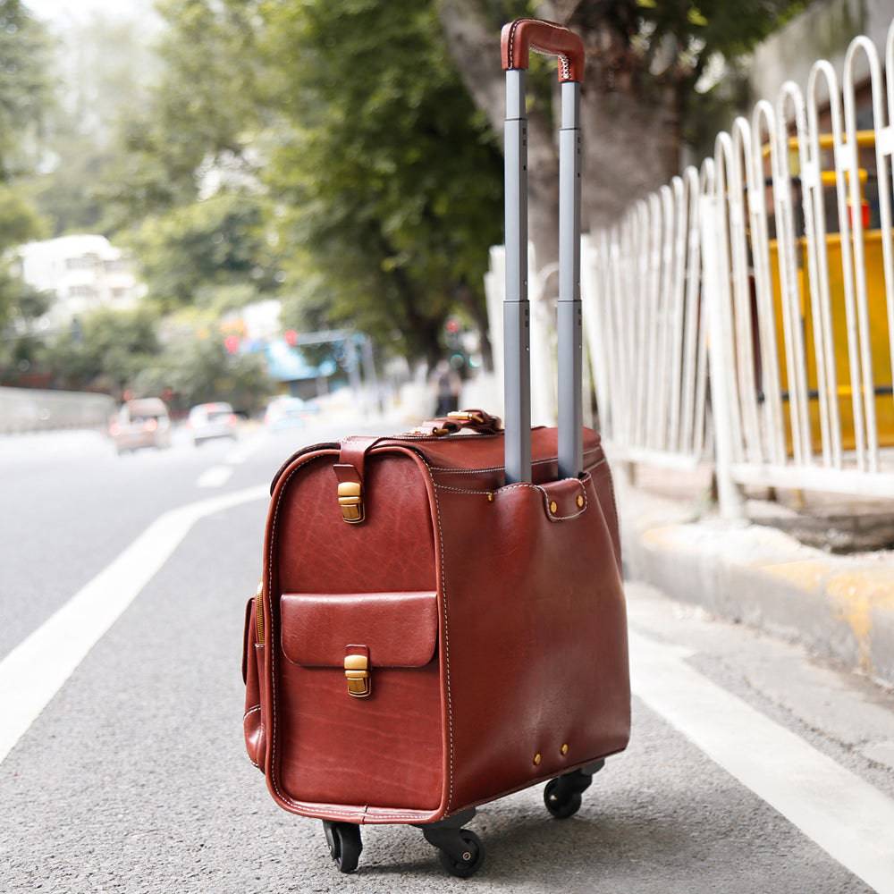 Vintage Rossie Viren 20-inch leather carry-on rolling suitcase with spinner wheels, brown vegetable-tanned leather travel luggage.