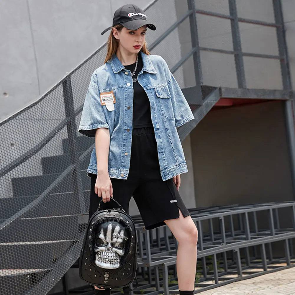 Rossie Viren 3D skull backpack with studded design, featuring a hair detail, designed as a stylish messenger bag.