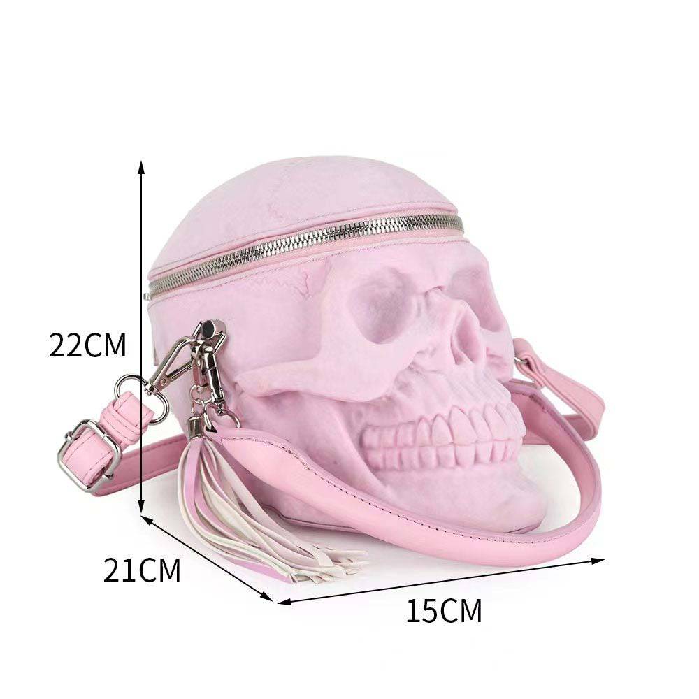 Pink suede 3D skull crossbody shoulder bag with mini handle by Rossie Viren, featuring bold design and compact style.